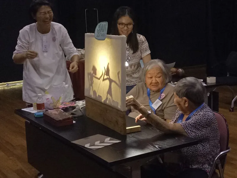 Participants at Malay Heritage Centre engaging in Wayang Kulit weaving activity